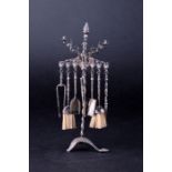 A Continental white metal miniature candelabra with hanging miniature items such as coal shovels,