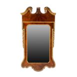 A George I style walnut and giltwood framed wall mirror with broken scroll pediment over shaped