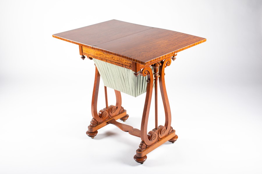 An early 20th century sewing and games table rectangular top section opens to reveal a games table