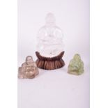 A large rock crystal seated Buddha seated on an unusual pedestal  along with a jade and a smokey