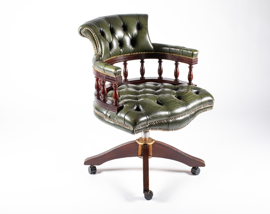 A 20th century mahogany captain's chair with green button leather upholstery, 62 cm wide x 88 cm