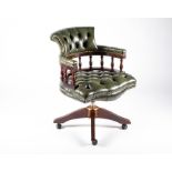 A 20th century mahogany captain's chair with green button leather upholstery, 62 cm wide x 88 cm