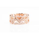A 9ct rose gold and diamond heart design ring the openwork eternity band half with diamond-set
