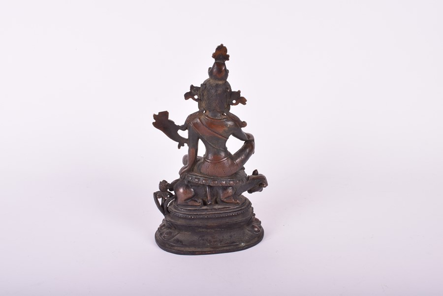 A South East Asian bronze deity, possibly Tara the goddess sits above a crouching guardian, raised - Image 2 of 5