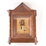 A 19th century Russian icon with parcel gilt riza in kiot the icon depicting Christ clasping the