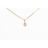 A yellow gold and diamond pendant the mixed oval-cut diamond of approximately 0.33 carats, set in