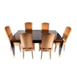 A French Art Deco rosewood dining table of rectangular form with slight curved sides, raised on four