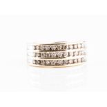 A 9ct yellow gold and diamond band ring channel-set with three rows of round brilliant-cut diamonds,