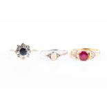 A 9ct yellow gold, diamond, and ruby ring centred with a mixed round-cut ruby with diamond accents