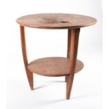 A French Art Deco coffee table by Louis Majorelle c.1900, the circular top with tripart veneer,