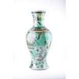 A Chinese Kangxi period Famille Verte cafe-au-lait ground vase of baluster form with various figures
