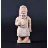 A Chinese pottery Tang Dynasty figure of an elder in a long robe with traces of original pigment,