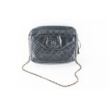 Chanel. A vintage black quilted leather handbag rectangular, the side pocket with embossed CC motif,