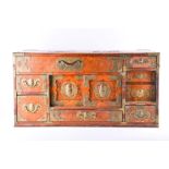 An early 20th century Chinese brass bound table cabinet with multiple drawer and slide