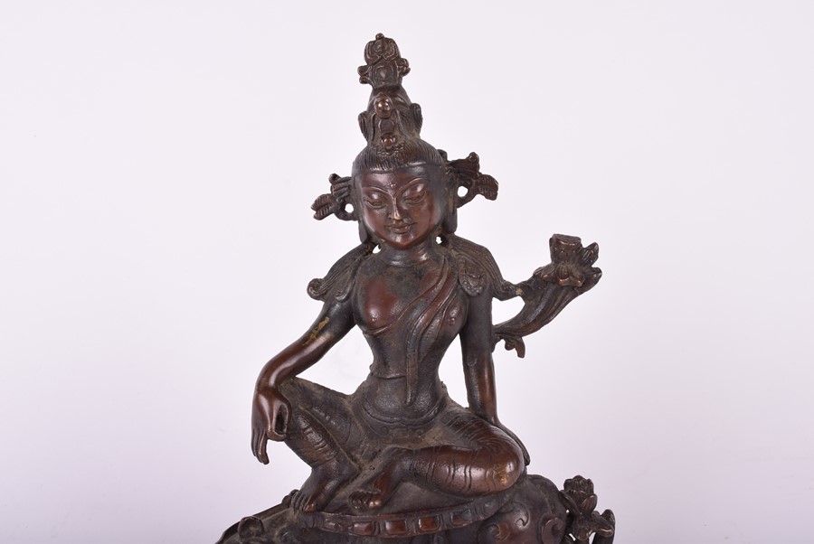 A South East Asian bronze deity, possibly Tara the goddess sits above a crouching guardian, raised - Image 4 of 5