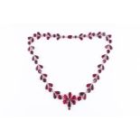 An impressive 19th century flat-cut garnet necklace of floral and foliate design, centred with a