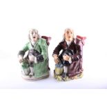 Two 19th century 'Nightwatchman' toby jugs one on a Prattware-type base, each 23.5 cm high. (2)