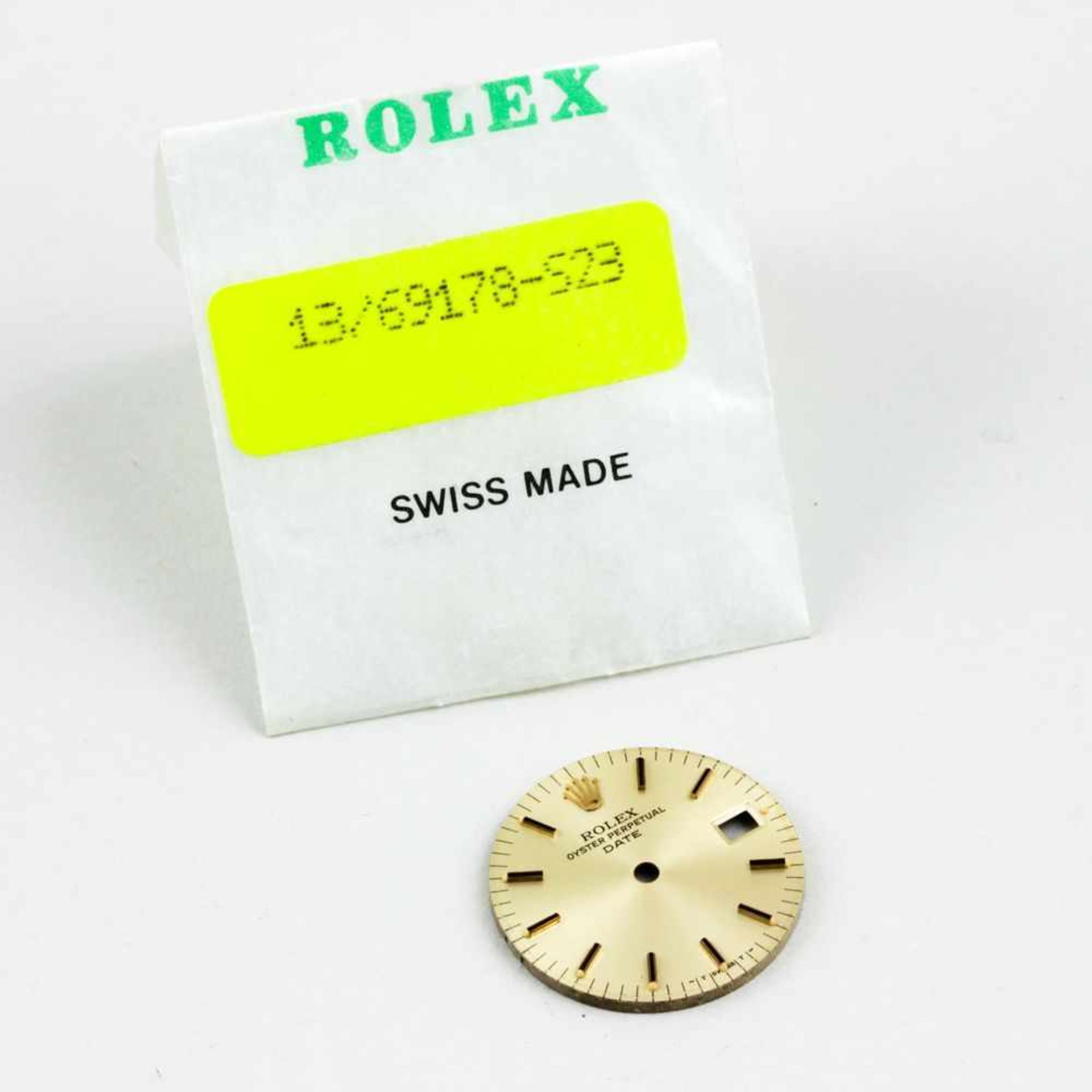 Goldenes Rolex Damenuhren-Zifferblatt,"Oyster Perpetual Date". D. 2 cm. In Original-Verpackung.