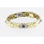 Bicolor gouden armband bezet met cabochon blauwe safieren en diamant briljantslijpsel, ca. 0.7ct.