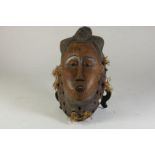 Houten gestoken Baule vrouwen masker met open mond en half gesloten ogen, Ivoorkust, l. 40 cm.Wooden