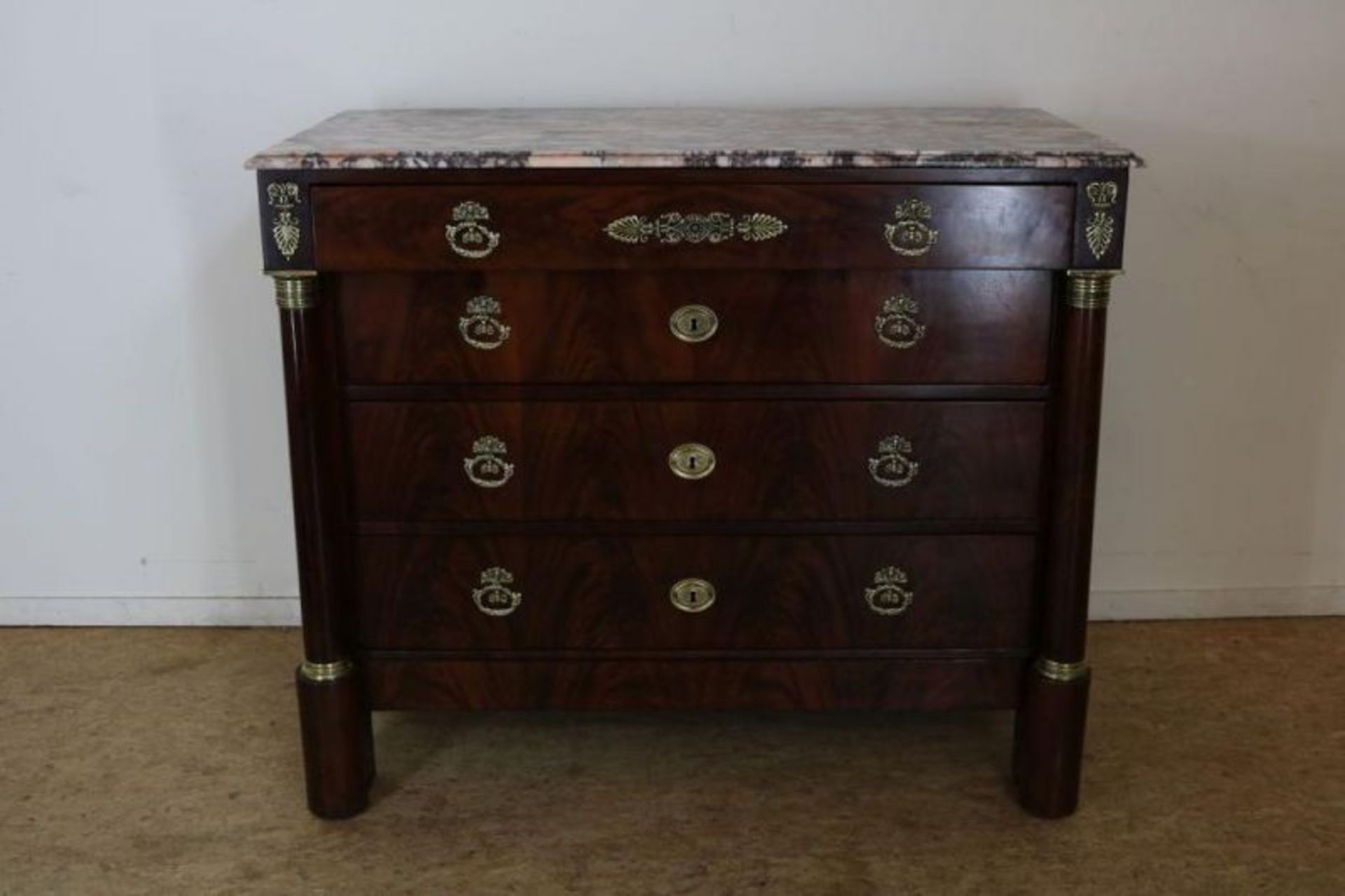 Mahonie Empire commode onder marmeren blad met 4 laden afgezet met bronzen beslag, ca. 1810, h.