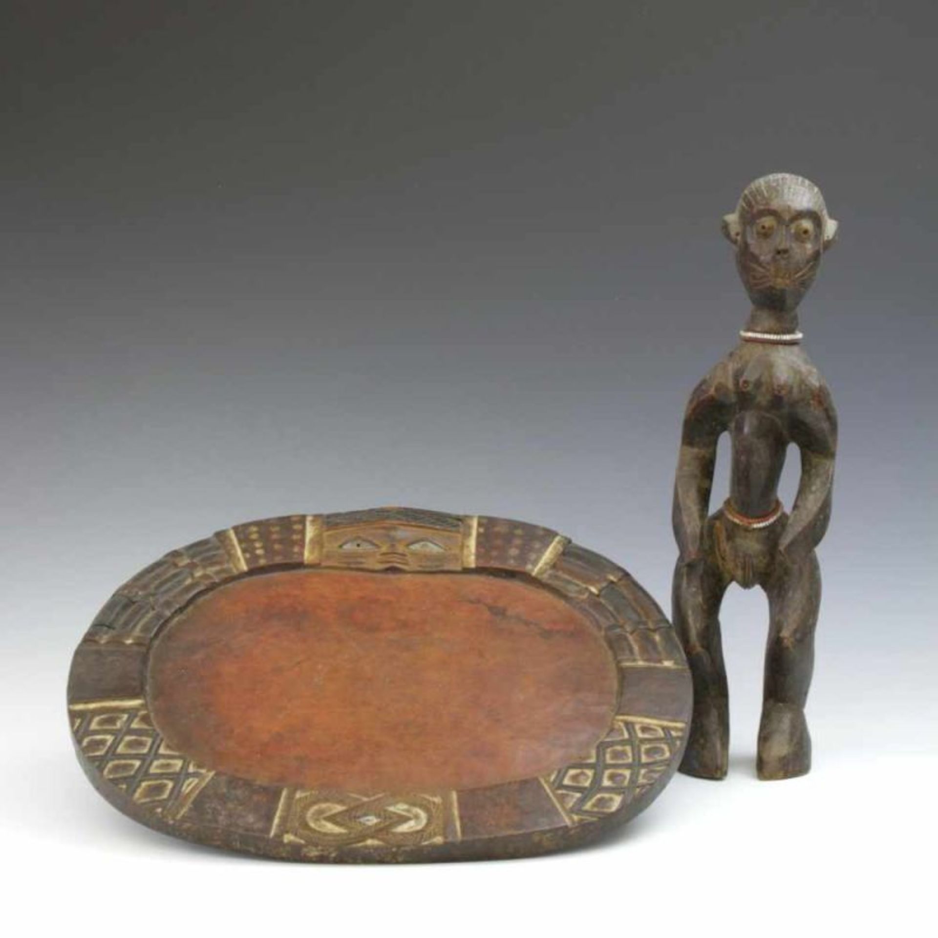 Yoruba, wooden Ifa dish and Nigeria, standing female figure (leg broken)w. 36 and h. 36 cm.; [2]