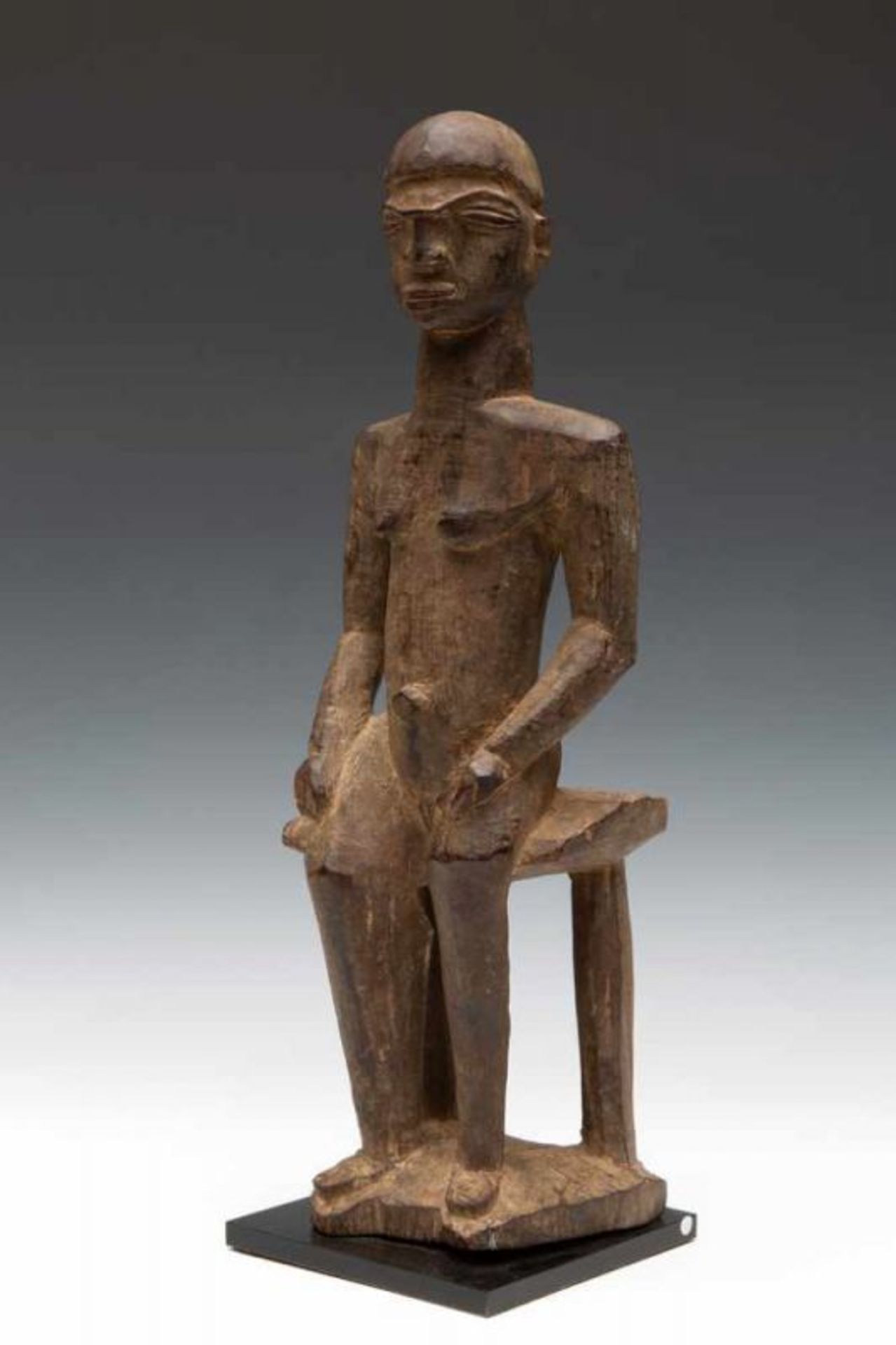 Burkina Faso, Lobi, seated female figure, Bateba Bambara.Protective function of the home. Carved