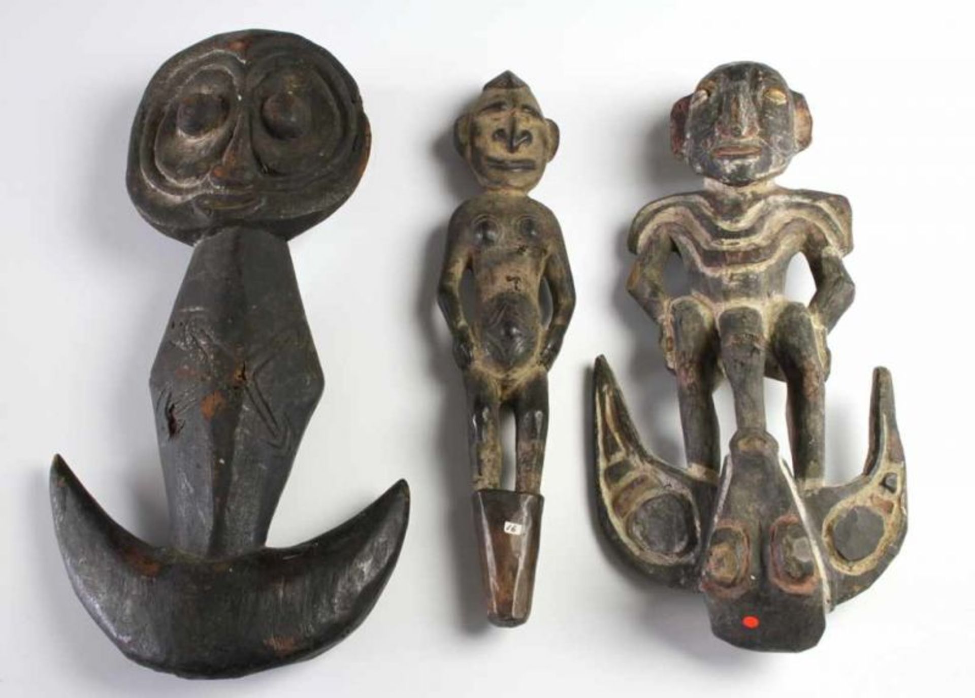 PNG, Sepik, wooden hook figure,with carved concave face, four arrows on rhombic shaped body. With