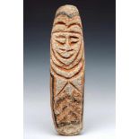 Vanuatu, carved stone border stele,showing an anthropomorphic head in deep relief, with red pigments