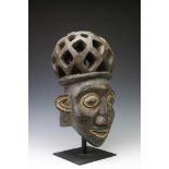 Cameroon, Bamileke, helmet mask,with open worked hairstyle and with black pigments and accents in