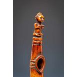 DRC., ivory horn, ca. 1920,with a carved seated figure, leather and textile bound at the end.