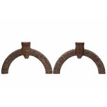 New Sealand, Maori, two wooden semi circular lintels, showing various motifs, the eyes inset with