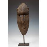 PNG, Sawos, elongated mask, crusty blackish patinaProvenance ex coll. Peter Hallinan, Alex Arthur