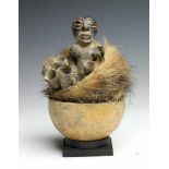 DRC., Songhe, halffigure in calebasfetish object; filled with horns, earth matrial and animal