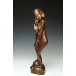 Java, carved wooden sculpture of a bathing woman, ca. 1940.Herewith a wooden sculpture of two