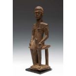 Burkina Faso, Lobi, seated female figure, Bateba Bambara.Protective function of the home. Carved