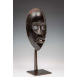 Ivory Coast, Dan, face maskwith protruding lips, oval cut eyes and bulbous forehead. With glossy