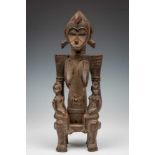 Ivory Coast, Senufo, wooden seated female figure with a child on each kneeProvenance: Huguenin; h.