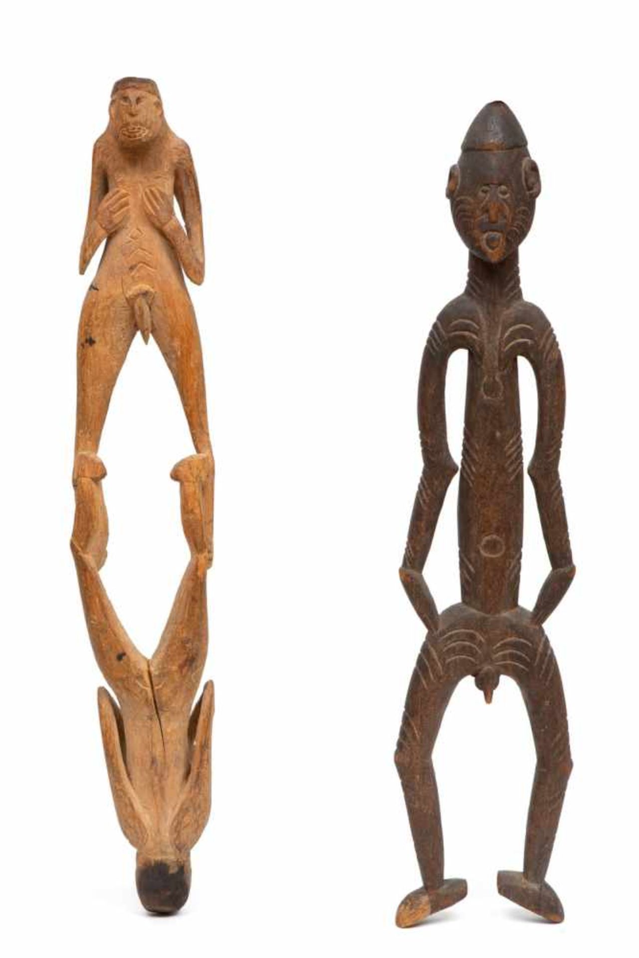 Papua Barat, Asmat, carved wooden male figure and male-female double figureProvenance: Private Dutch
