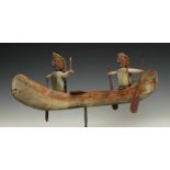 North America, carved wooden miniature boatwith two seated rowers with peddles. With remnants of