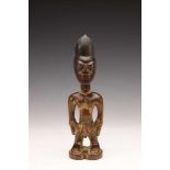 Yoruba, Oyo, standing male Ibeji,with hands resting on the hips, rows of scarification on the face