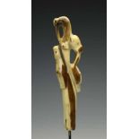Arctic Circle, Inuit, finely carved walrus tusk handle,in the shape of a polar fox, a seal topped by