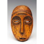 DRC., Lega, ivory mask, lukungu.oval mask with hart shaped face, raised ridge with carved zig-zag