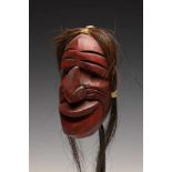 North America, Iroquois, small false face mask, ca. 1950,with red pigments and hair.; l. 15 cm.; ;