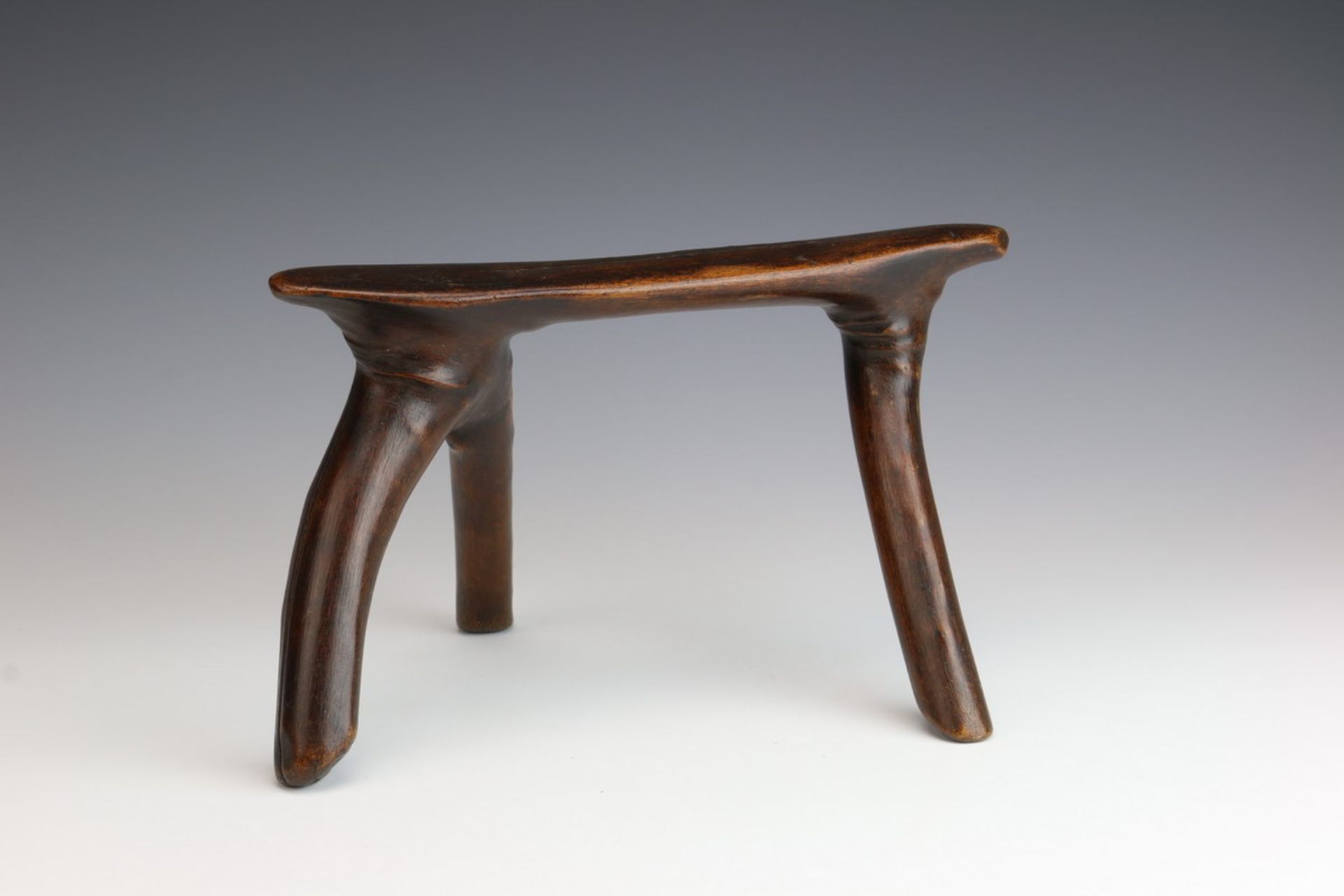 South Sudan, Dinka, wooden neckrest,with three curved legs. With glossy dark brown patina. Private