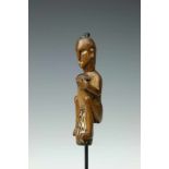 Papua Barat, Lake Sentani, wooden sculpture of a man playing a drumdetails in white