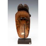 Ivory Coast, Guro, face mask,with curved horns, beard and goatee. Painted in black with accents in