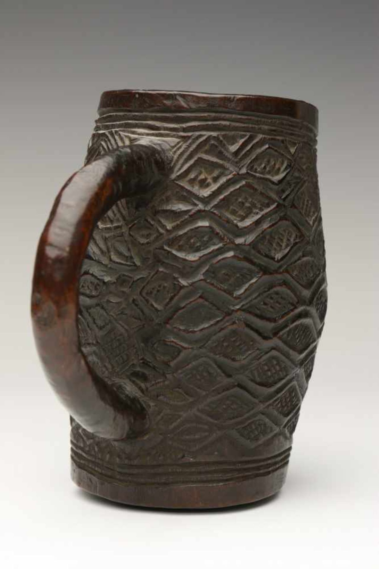 DRC., Kuba Kingdom, old carved wooden palm wine cup,with carved geometrical patterns and black brown
