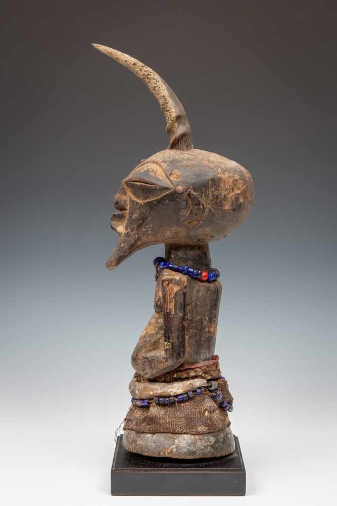 DRC., Songhe, halffigure,with horn, beaded necklaces, animal skins and remnants of offering. Ex
