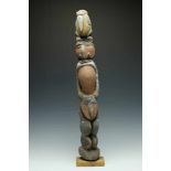 PNG, Maprik, carved wooden male ancestral figure,surmounted by a stylized bird. With natural